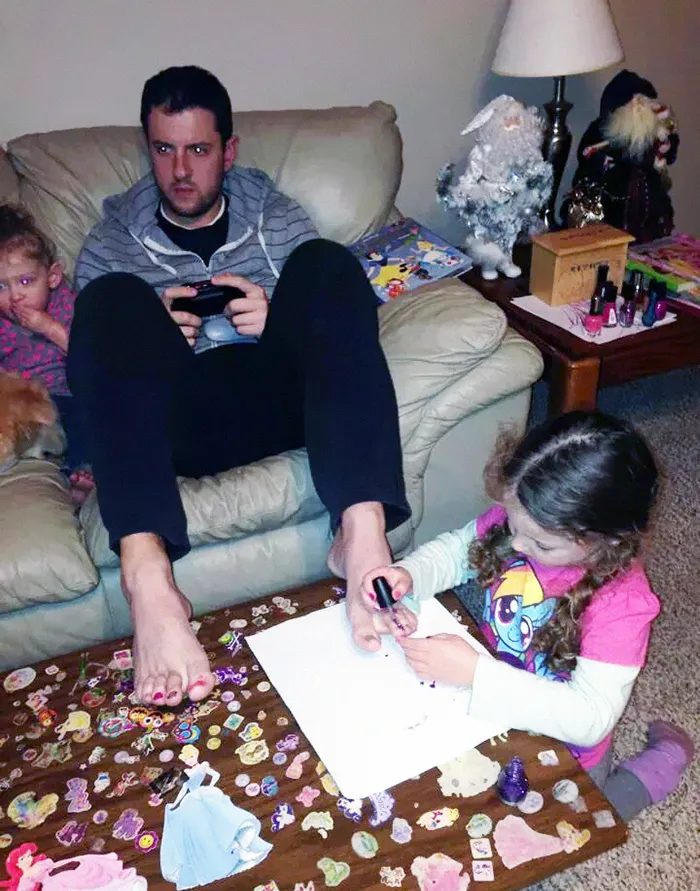 Letting His Daughter Do His Nails While Playing A Video Game