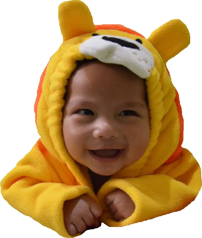 Smiling baby dressed in a bright yellow and orange Halloween costume, cute children's Halloween costume ideas.