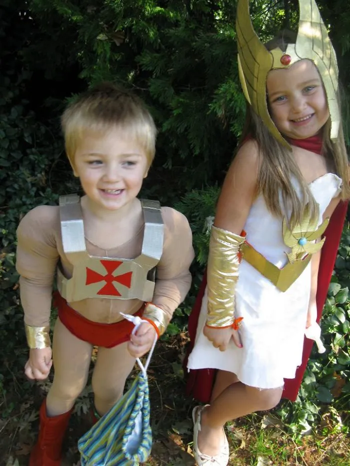 Two children outdoors dressed in creative children's Halloween costume ideas featuring a hero and warrior theme.