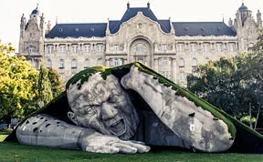 A Giant Sculpture Crawls Out Of The Ground In Public Square Of Budapest