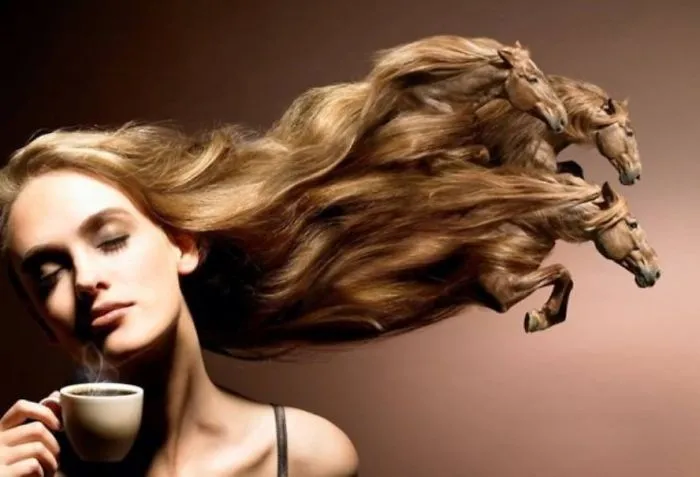 Woman with a crazy haircut resembling galloping horses, holding a cup of coffee.