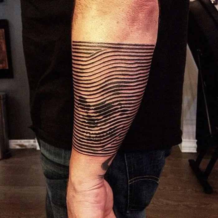 3D tattoo with optical illusion lines on a forearm, creating a mind-twisting visual effect.