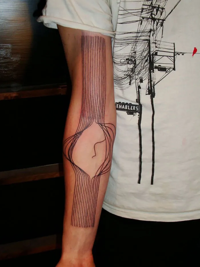 A forearm with a crazy 3D tattoo featuring intricate line work creating an optical illusion, seen under indoor lighting.