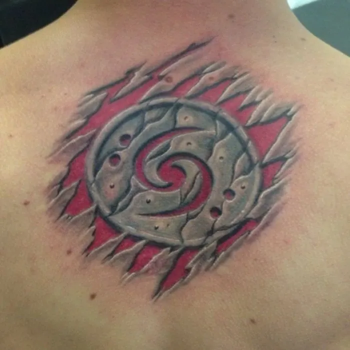 3D tattoo of a spiral design with a torn skin effect on a person's back.