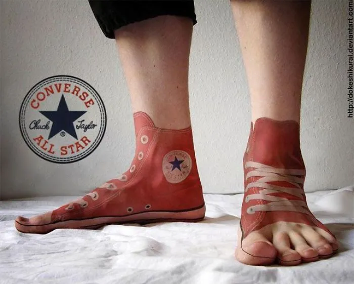 3D tattoo of Converse sneakers on feet; optical illusion design.