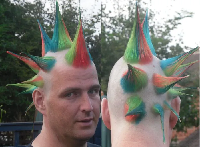 Man with a colorful spiked mohawk, showcasing one of the craziest haircuts ever.