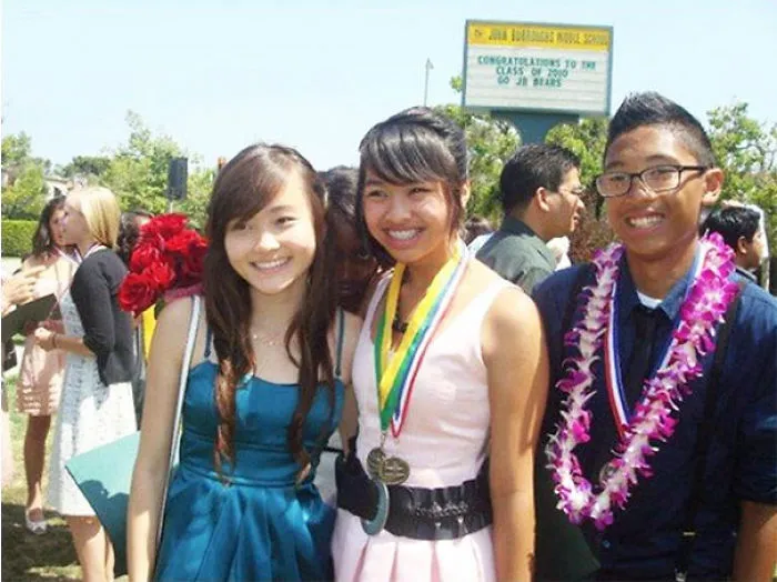 Smiling students at graduation with hidden detail that'll make you look twice.