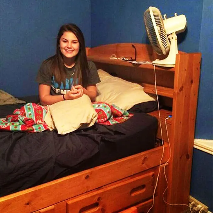 Girl sitting on a bed with a hidden detail that might surprise viewers.