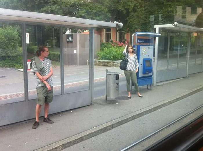 Woman and man standing and wearing similar clothes