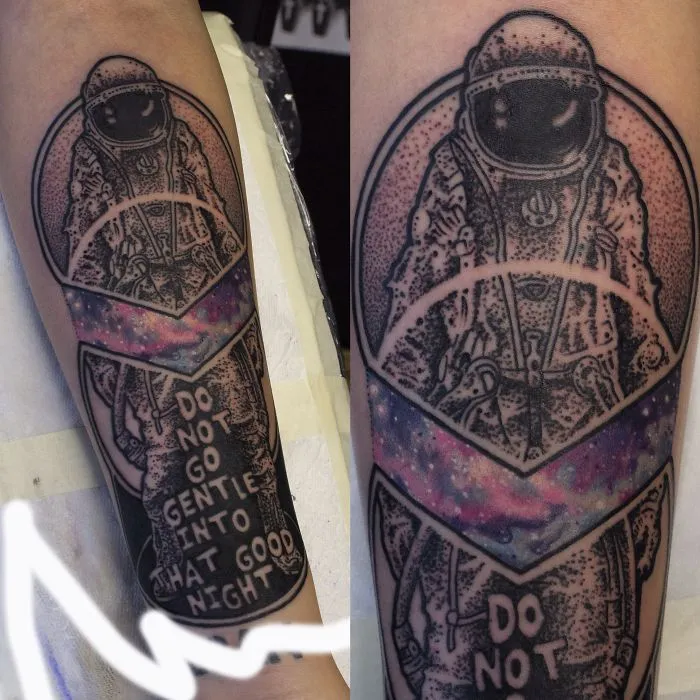 Colorful cosmic tattoo of an astronaut on an arm, featuring space motifs and text.