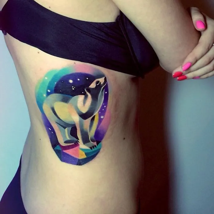 Colorful polar bear space tattoo on cheekbone, ideal for astronomy enthusiasts.