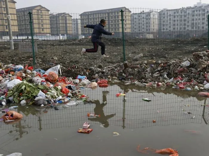 Child Jumps Over Trash At A Village, Jiaxing