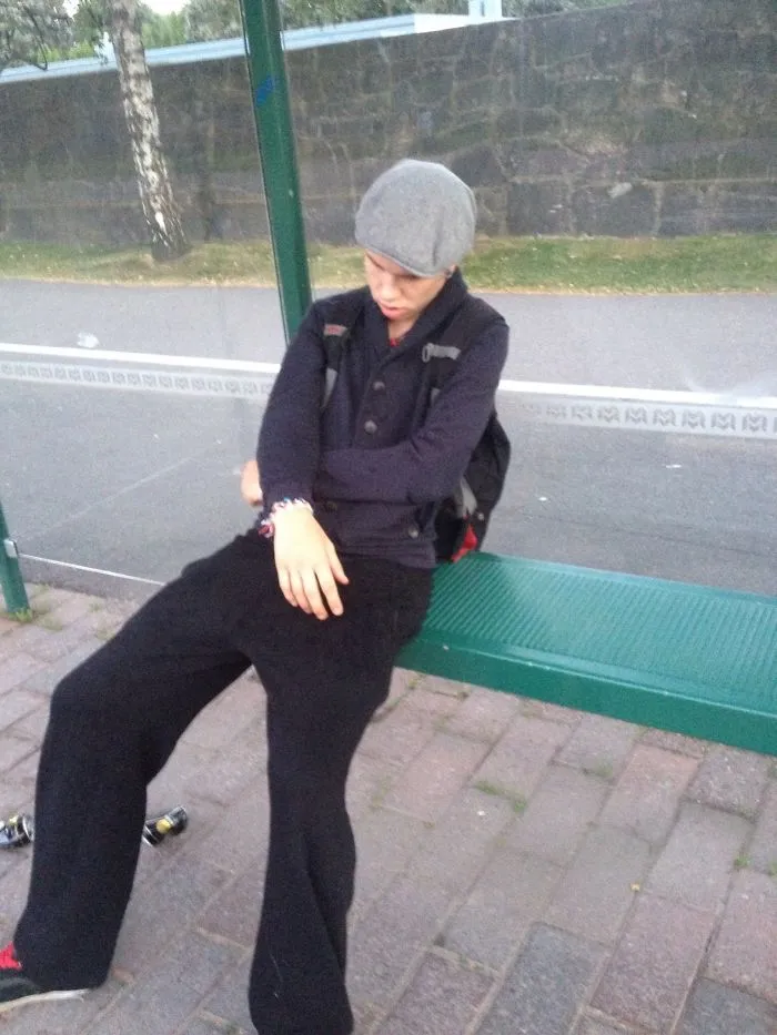 A Sleepy Teenager Waiting For A Bus In Helsinki, Finland.