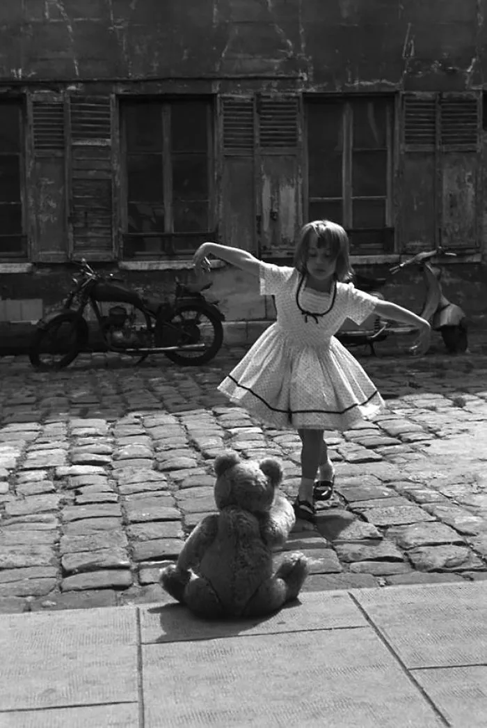 Girl Dancing In Front Of Her Teddy Bear. Paris, 1961