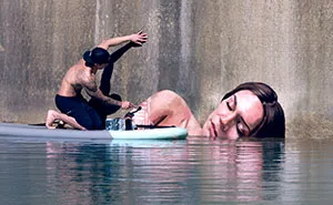 Artist Paints Stunning Seaside Murals While Balancing On A Surfboard