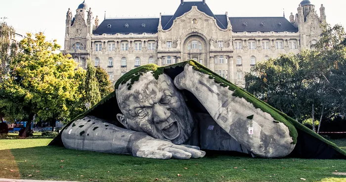 A Giant Sculpture Crawls Out Of The Ground In Public Square Of Budapest