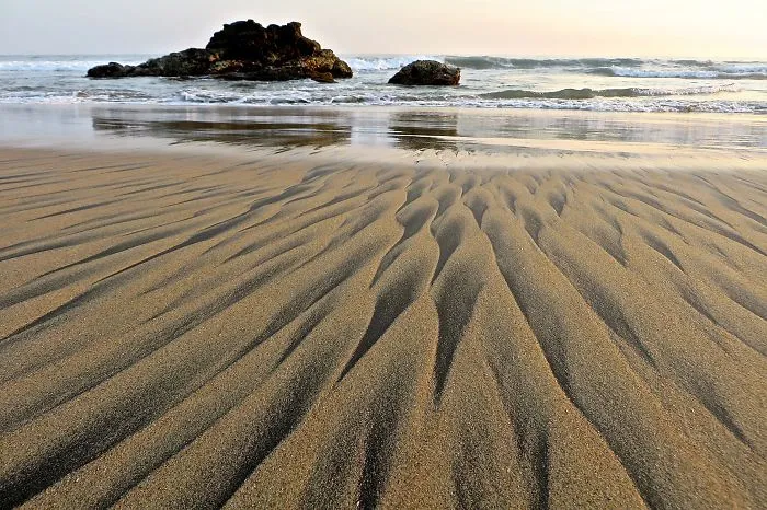 The Wave Left Behind Sand People On The Beach