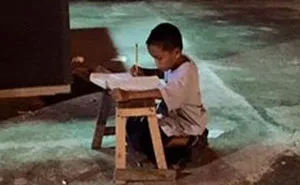 Homeless Boy Does His Homework Using The Light From A Local McDonald's