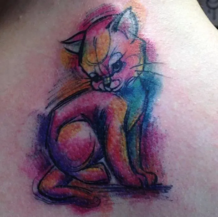 Colorful line art cat tattoo design on skin, featuring vibrant rainbow hues for cat lovers.
