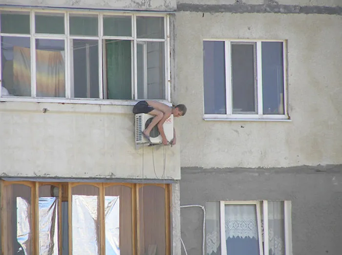 Man Balanced On Ventilation Unit