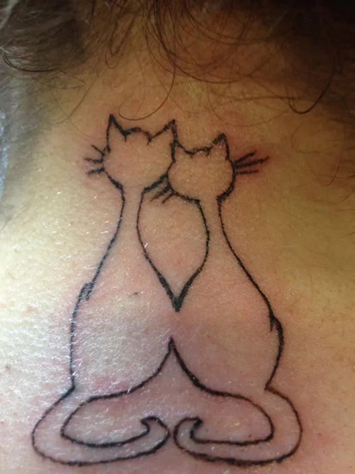 Line art of two simple cat tattoo designs on the back, ideal for cat lovers.
