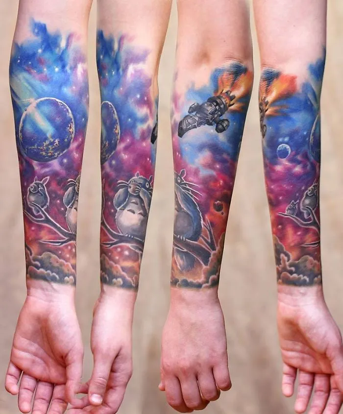 Studio Ghibli Totoro tattoo featuring colorful scenes from Miyazaki films on forearms.