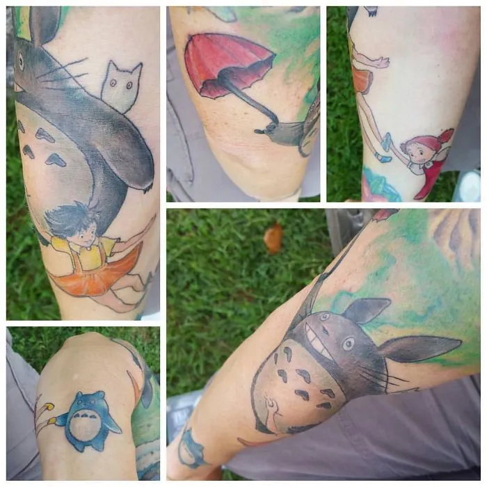 Studio Ghibli tattoos featuring Totoro and other Miyazaki film characters on a person's arm.