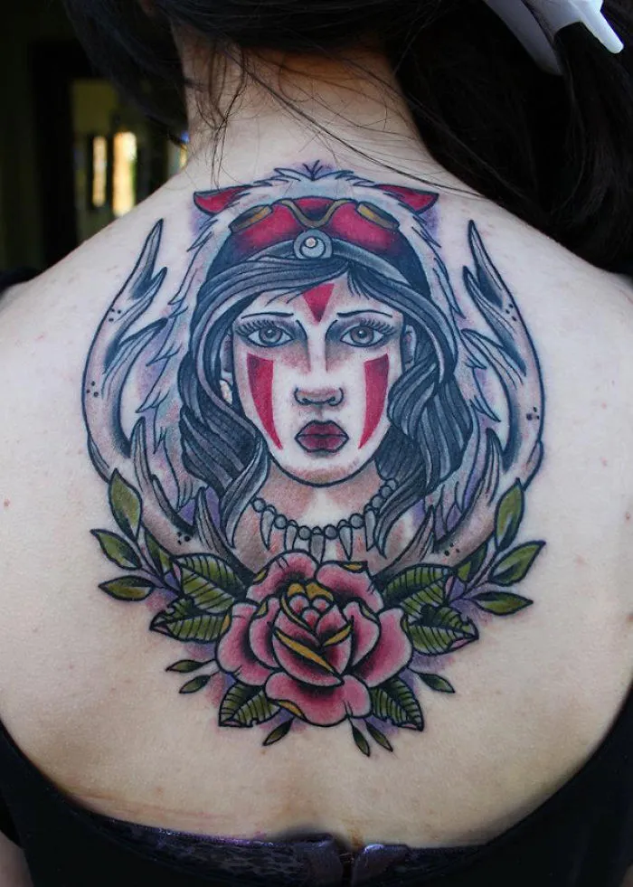 Studio Ghibli tattoo featuring a character Princess Mononoke with tribal markings and floral elements on the back.