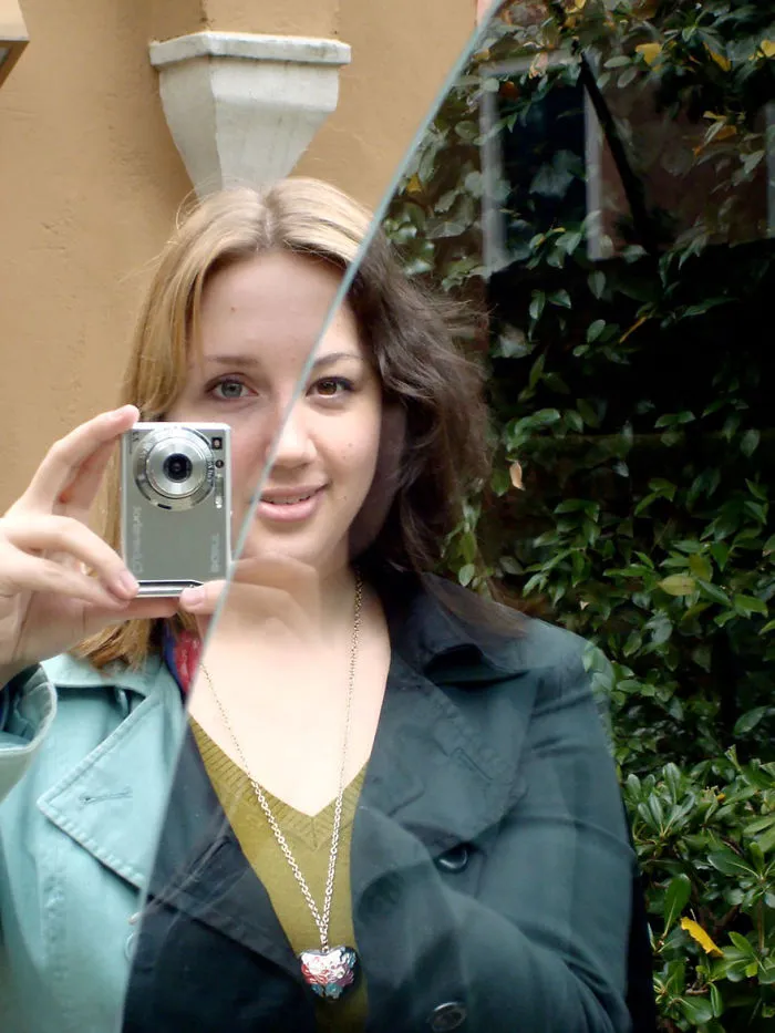 The Left-Hand Side Is A Mirror, And The Right-Hand Side Is Clear Glass, With A Friend Standing On The Other Side