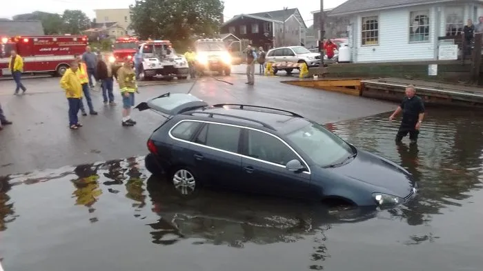 Man Drives His Car Down A Boat Launch And Into A Harbor