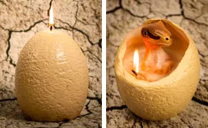 Dinosaur Egg Candle That "Hatches" A Baby Raptor When It Melts