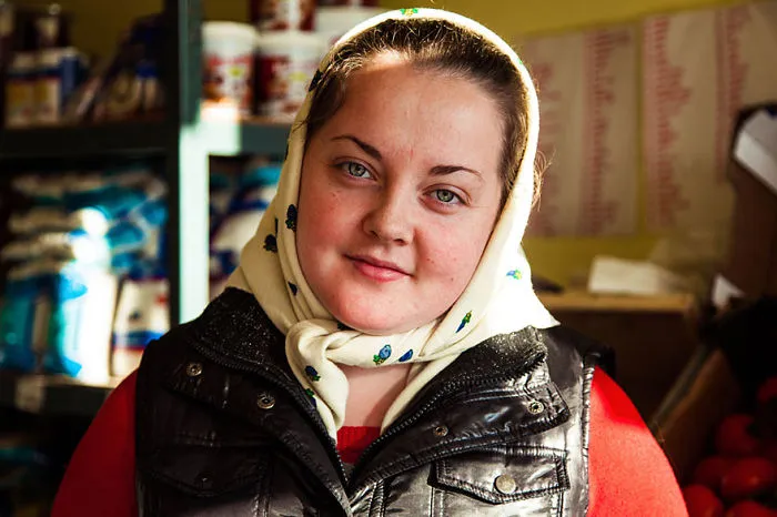Romanian photographer captures woman's portrait, showcasing diverse beauty in everyday setting.