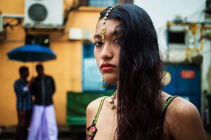 Romanian photographer captures woman showcasing diverse beauty in a vibrant urban setting.