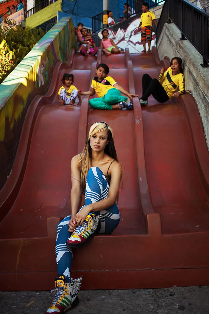 Woman photographed in colorful attire on a slide, symbolizing diverse beauty by Romanian photographer.