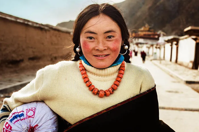 Woman from Tibet photographed by Romanian photographer showcasing global beauty.