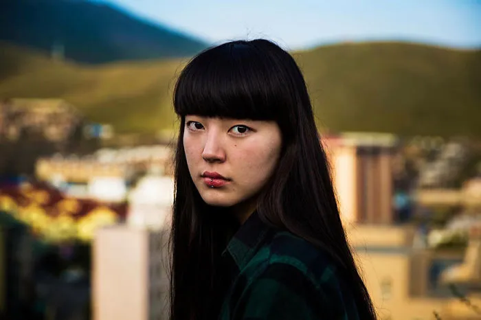 Woman photographed outdoors, showcasing beauty in diverse cultures by a Romanian photographer.