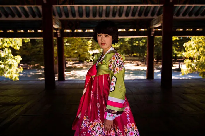 Woman in a colorful traditional dress representing diverse beauty, photographed by Romanian photographer.