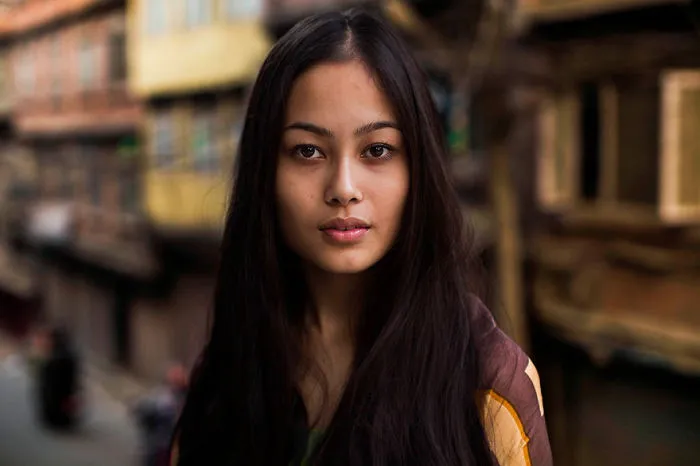 Woman photographed by Romanian photographer to showcase global beauty, standing in an urban setting.