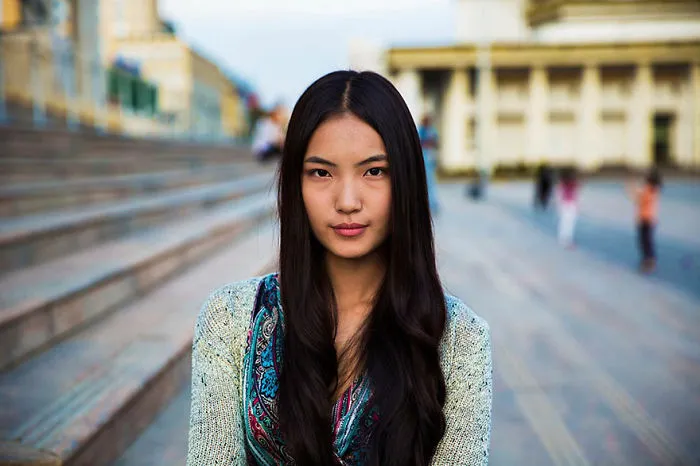 Romanian photographer captures woman's beauty in an urban setting, showcasing diverse charm.