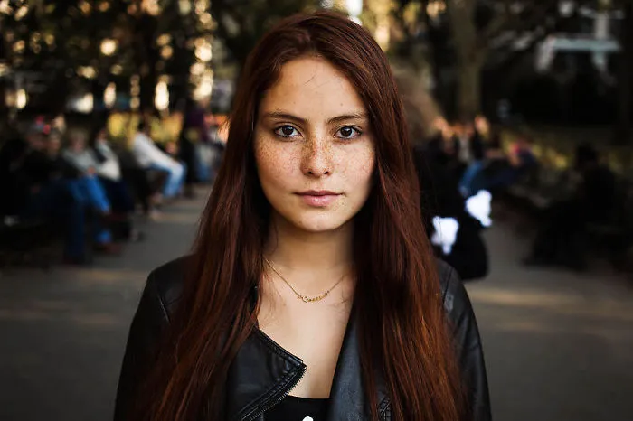 Portrait of a woman in a park, showcasing diverse beauty, captured by a Romanian photographer.