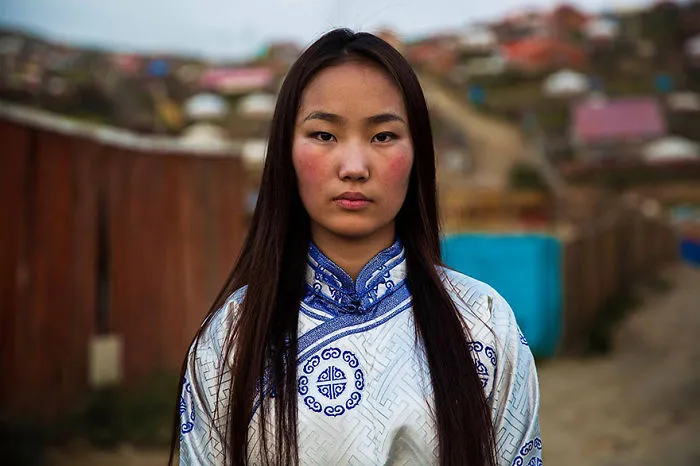 Woman in traditional attire photographed by a Romanian photographer, showcasing diverse beauty.