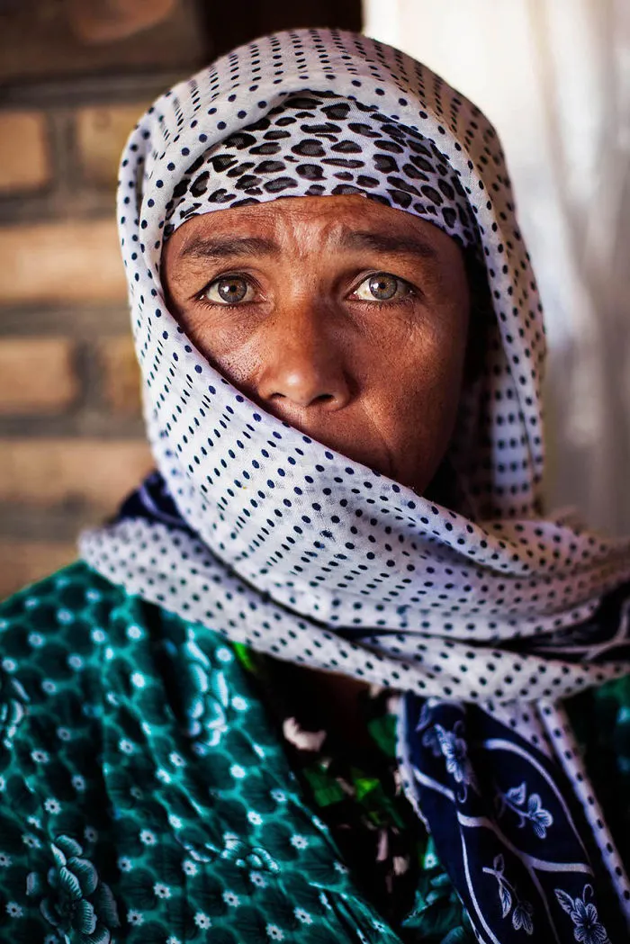 Woman in patterned scarf, photographed by Romanian photographer, showcasing global beauty.