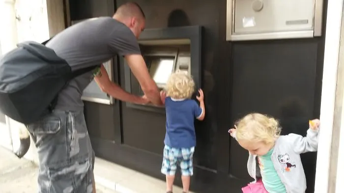 Man Withdrawing Cash From Atm In Italy