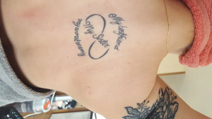 Tattoo with the words "My Sister" in infinity symbol, symbolizing sister bond.