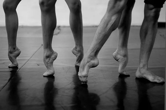 Ballet dancers on tiptoe, showcasing the strength and grace required in ballet.
