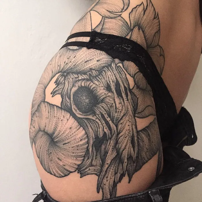 Dark and eerie creature tattoo on arm showcasing intricate design by a Russian artist.