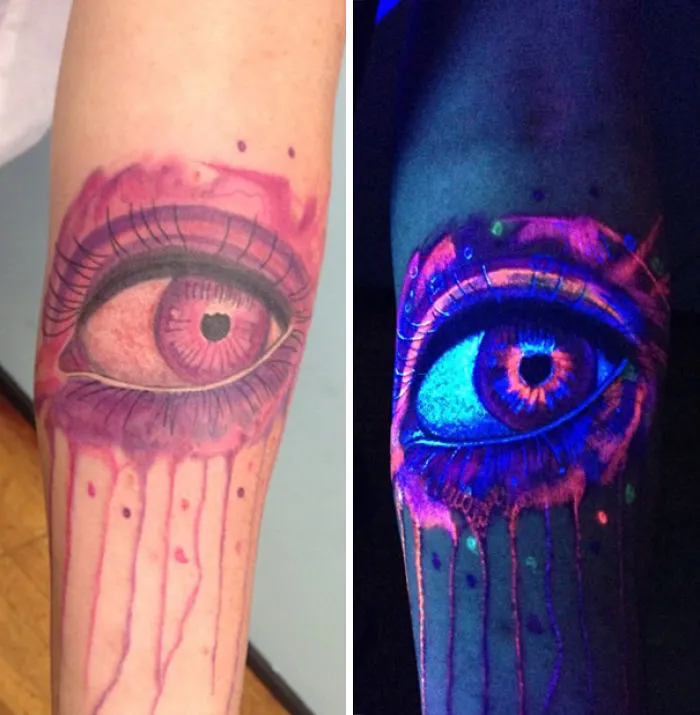 Glow in the dark tattoo of an eye, vibrant under black light, showing intricate details and fluorescent colors.