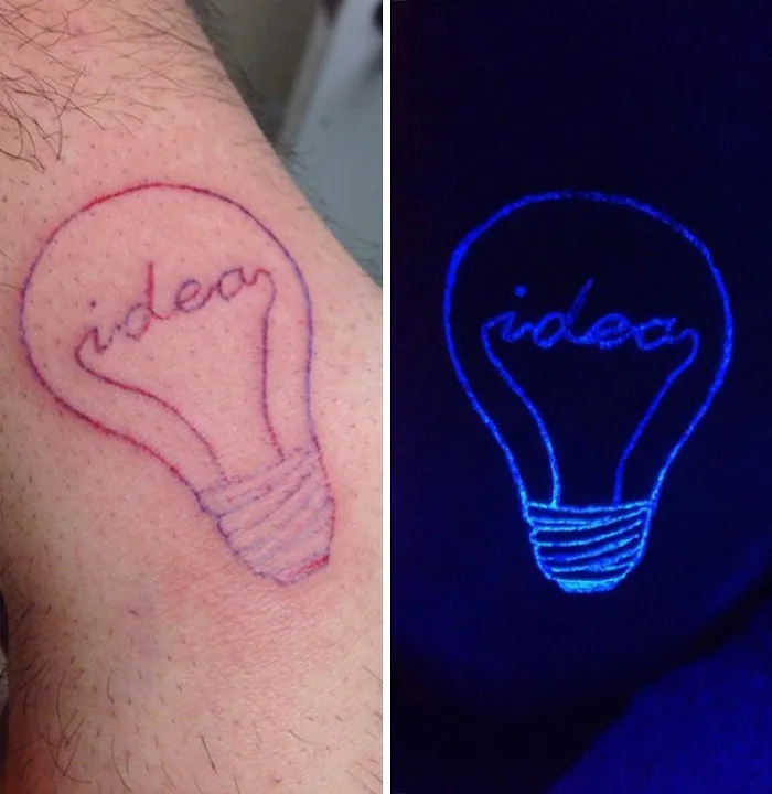 Glow in the dark tattoo of a light bulb with the word "idea," visible under black light.