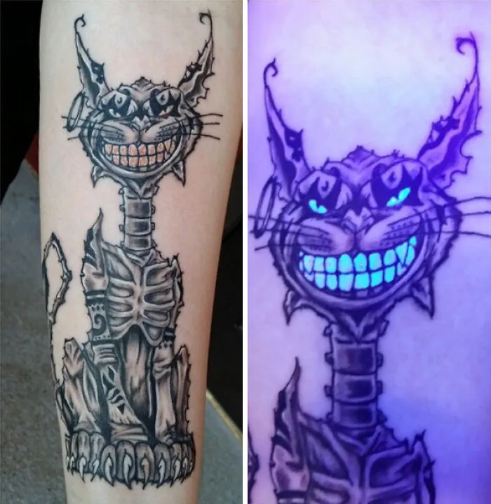 Glow in the dark tattoo of a grinning cat, visible under black light.