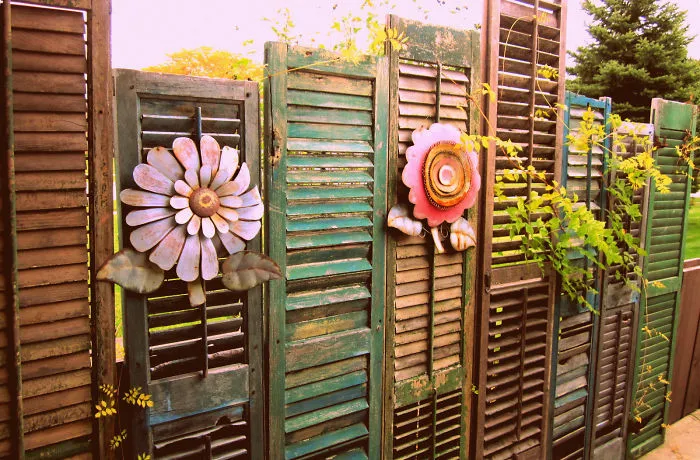 Flower Decor On A Fence Made From Old Shutters